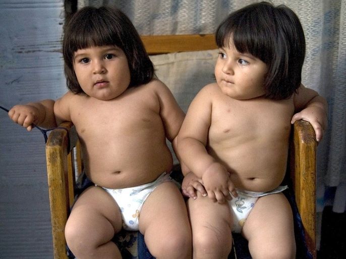 Colombian twins Juan Manuel and John Anderson Giraldo sit in a chair at their house on September 21, 2011 in Medellin, Antioquia department, Colombia. The twins are 18 months old and weigh 16 kilos, while their ideal weight should be 11 kilos. The latest results from the Colombian National Health and Nutrition Situation reveal that infant obesity is on the rise, with one in six children between the ages of 5 to 17 considered to be overweight or obese.