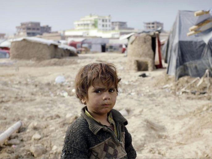 An internally displaced Afghan child stands at a refugee camp on the outskirts of Kabul, Afghanistan, Wednesday, Dec. 12, 2012. More than 2 million Afghans are at risk from cold, disease and malnutrition this winter as an international appeal for funds to help one of the world's poorest countries has fallen drastically short of its goal, the United Nations and several humanitarian agencies warned on Wednesday.