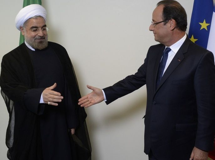 France's President Francois Hollande (R) shakes hands with Iran's President Hassan Rohani (L) on September 24, 2013 at Un Headquarters in New York.