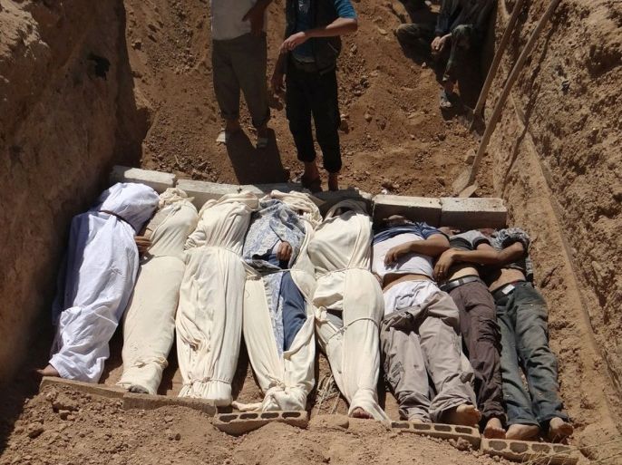 This image provided by by Shaam News Network on Thursday, Aug. 22, 2013, which has been authenticated based on its contents and other AP reporting, purports to show several bodies being buried in a suburb of Damascus, Syria during a funeral on Wednesday, Aug. 21, 2013. Syrian government forces pressed their offensive in eastern Damascus on Thursday, bombing rebel-held suburbs where the opposition said the regime had killed more than 100 people the day before in a chemical weapons attack. The government has denied allegations it used chemical weapons in artillery barrages on the area known as eastern Ghouta on Wednesday as "absolutely baseless."