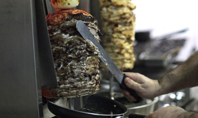 Khader Alkour, head chef at Hooka Cafe, slices pieces of beef shawarma Tuesday, June 19, 2012, at Hooka Cafe in Odessa, Texas. The Mediterranean cuisine restaurant plans to have a grand opening Saturday.