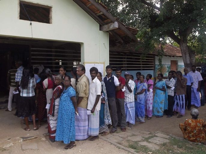 Tamils wait in line to cast their votes at a polling station during the first provincial polls in 25 years in Jaffna, a former war zone in northern Sri Lanka about 400 kilometres (249 miles) north of Colombo, September 21, 2013. Voters in northern Sri Lanka go to the polls on Saturday for a provincial election that threatens to stir up old animosity between the government and Tamils, four years after the military crushed separatist Tamil rebels and ended a 26-year war.