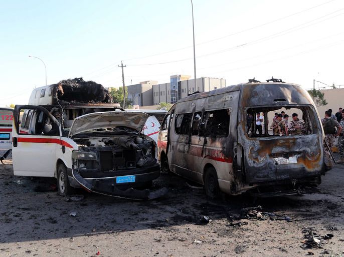 The wreckage of burnt ambulances are seen at the site of a car bomb explosion in Arbil, the capital of Iraq’s autonomous Kurdistan Region, on September 29, 2013. Militants killed six people, officials said, in a rare attack on an area usually spared violence plaguing the country. AFP PHOTO