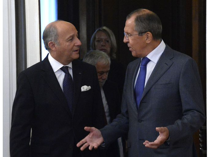 Russia's Foreign Minister Sergei Lavrov (R) speaks with his French counterpart Laurent Fabius during their meeting in Moscow, on September 17, 2013. Lavrov held talks today with French Foreign Minister amid differences over the wording wanted by Paris for a UN resolution calling on Syria to give up its chemical weapons stockpiles