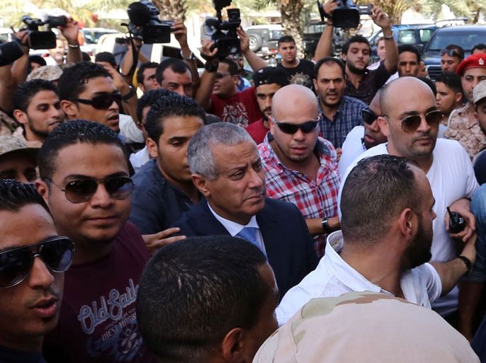 Libyan Prime Minister Ali Zeidan (C) arrives at the government headquarters in Tripoli on October 10, 2013 shortly after he was freed from the captivity of militiamen who had held him for several hours. Gunmen seized Zeidan from a hotel, where he resides, in the Libyan capital and held him for several hours before he was freed, in the latest sign of Libya's lawlessness since Moamer Kadhafi was toppled in 2011