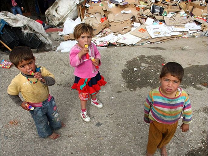 Syrian refugee children stand near their makeshift tents in central Ankara on October 12, 2013.
