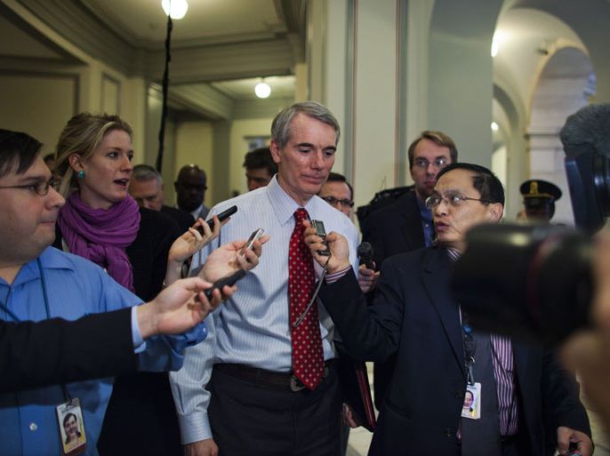 epa03011014 Republican Senator from Ohio and Super Committee member Rob Portman walks through a gauntlet of reporters as he exits a Super Committee meeting in Senator John Kerry's office in the Russell Senate Office Building in Washington, DC, USA 21 November 2011. The Super Committee was supposed to release their plan to cut the federal deficit by $1.2 trillion over the next decade this afternoon, though all signs point to the Committee's failure. EPA/JIM LO SCALZO