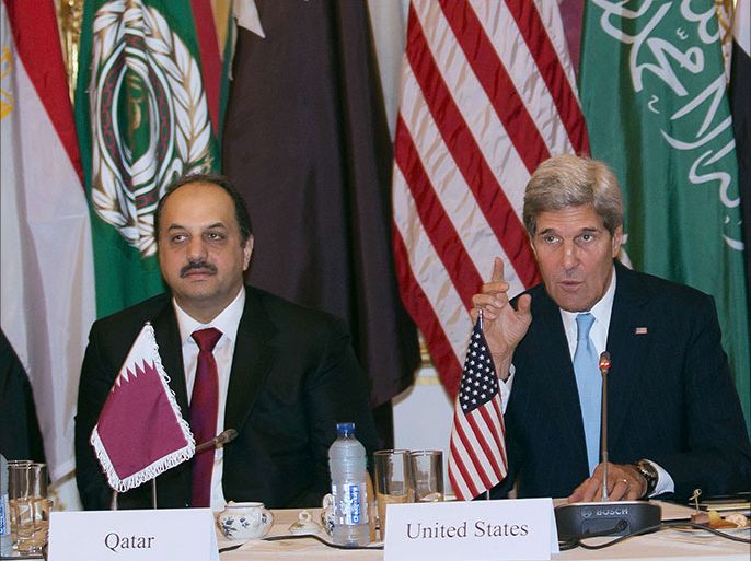 Qatar's Minister of State for Foreign Affairs Khalid bin Muhammad al-Atiyah (L) and US Secretary of State John Kerry (R) pose prior to a meeting with the Arab League in Paris on October 21, 2013. US Secretary of State John Kerry met Arab League representatives in Paris on the eve of a meeting of the Syrian opposition and its Western and Arab backers. AFP PHOTO