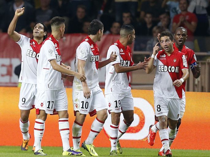 Monaco's Colombian forward Radamel Falcao (L) celebrates with teammates after scoring during the French L1 football match Monaco (ASM) vs Lyon (OL) on October 27, 2013 at the Louis II Stadium in Monaco. AFP PHOTO / VALERY HACHE