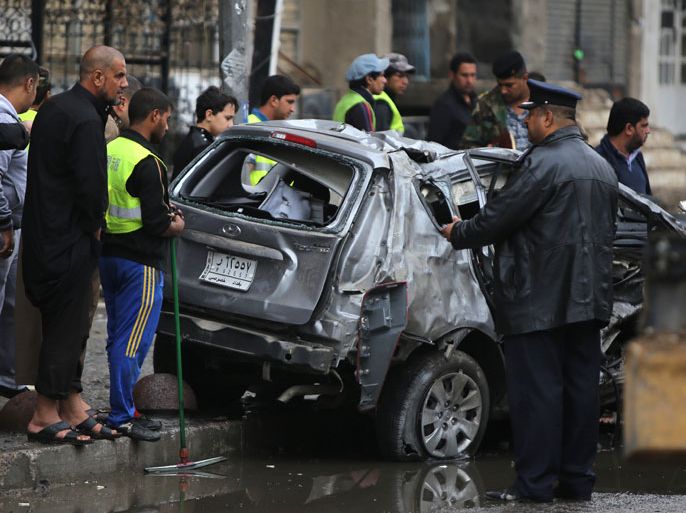 IRAQ : Iraqis inspect the site of a car bomb attack in the Karrada neighborhood in central Baghdad on November 20, 2013. A wave of attacks, most of them car bombs targeting Shiite neighbourhoods, rocked Baghdad today, killing at least 28 people in the latest bout of bloodshed to hit Iraq