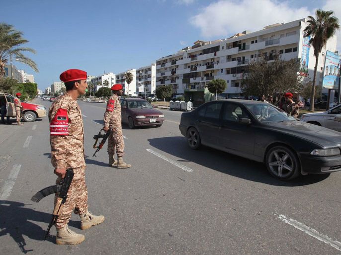 epa03941191 Libyan Military Police checks cars at a checkpoint in a street of the capital after a night of heavy clashes between rival militia groups in Tripoli, Libya, 08 ovember 2013. At least one person was killed during overnight clashes between rival militias in the Libyan capital, a medical official at Tripoli's Central Hospital said 08 November. The fighting, which took place in the district of Suq al-Juma, in eastern Tripoli, also left several people wounded. Heavy weapons were used in the gun battle, which continued until the early hours of 08 November, according to witnesses. Several buildings, including the Radisson Blue Hotel, were slightly damaged by the gunfire. EPA/SABRI ELMHEDWI