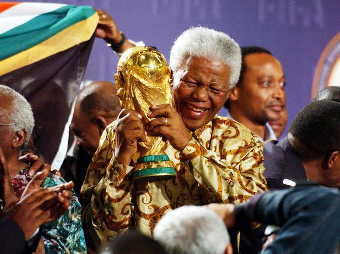 epa03978366 (FILE) A file picture dated 14 May 2004 shows Nobel Peace Prize winner and iconic political prisoner Nelson Mandela lifting the World Cup trophy in Zurich, Switzerland, after it was announced that South Africa will host the Soccer World Cup 2010. According to media reports Nelson Mandela has died aged 95, in Johannesburg, South Africa, on 05 December 2013. A former lawyer, Mandela was the first black President of South Africa voted into power after the countries first free and fair democratic elections that witnessed the end of the Apartheid system in 1994. Mandela was founding member of the ANC (African National Congress) and anti-apartheid activist who served 27 years in prison, spending many of these years on Robben Island. In South Africa, Mandela is often known as uTata Madiba, an honorary title adopted by elders of Mandela's clan. Mandela won the Nobel Peace Prize in 1993. EPA/STEFFEN SCHMIDT