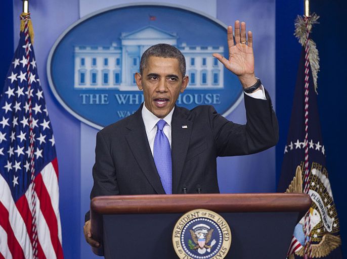 US President Barack Obama waves at the conclusion of a press conference in the Brady Press Briefing Room at the White House in Washington, DC, December 20, 2013. AFP