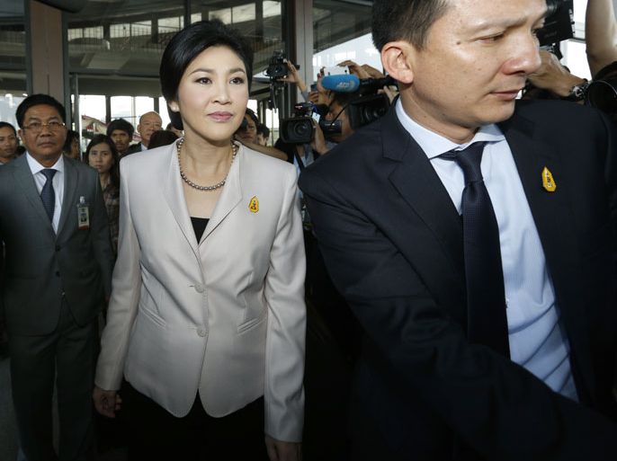 epa03984227 Caretaker Thai Prime Minister Yingluck Shinawatra (C) leave after a meeting with her cabinet at the Thai Army Club in Bangkok, Thailand, 10 December 2013. Yingluck has been selected by her Pheu Thai Party as its candidate for the premiership in a general election scheduled on 02 February 2014, news reports said on 10 December 2013, after her decision to dissolve parliament on 09 December 2013 in the face of mass demonstrations against her government that showed no sign of being called off while thousands of protesters march on Government House to topple the government and rid the country of the political influence of fugitive former prime minister Thaksin Shinawatra, Yingluck's elder brother. EPA/NARONG SANGNAK