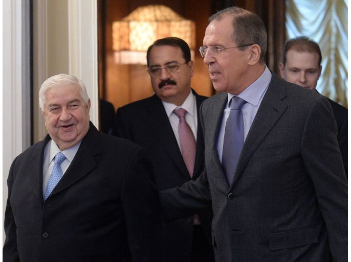 Russia’s Foreign Minister Sergei Lavrov (R) welcomes his Syrian counterpart Walid al-Moallem in Moscow, on January 17, 2014. Russia launched a fresh round of Syrian diplomacy on as it hosted the foreign ministers of Iran and Syria ahead of peace talks in Switzerland. AFP PHOTO