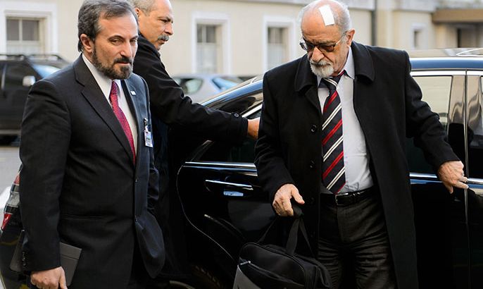 Syrian Opposition delegation spokesman Louay Safi (L) and veteran Syrian opposition figure and prominent Syrian human rights activist Haitham al-Maleh arrives on the fourth day of peace talks at the United Nations Offices in Geneva on January 28, 2014. Syrian peace talks were due to resume in Geneva on Tuesday with the warring sides deadlocked over the explosive issue of transferring power from President Bashar al-Assad's regime. AFP