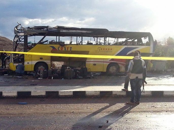 A picture taken on February 16, 2014, shows the wreckage of a tourist bus at the site of a bomb explosion in the Egyptian south Sinai resort town of Taba. A bomb tore through a bus carrying South Korean tourists near an Egyptian border crossing with Israel, killing at least four people and wounding 13, officials said. AFP PHOTO / STR