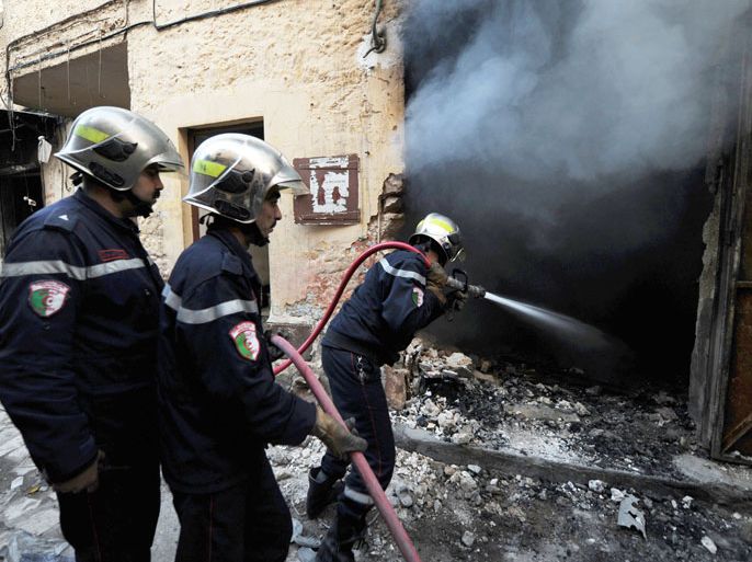Algerian firemen extinguish a fire following sectarian clashes on March 16, 2014 in the town of Ghardaia, some 600 kilometres (370 miles) south of Algiers. The city of 90,000 inhabitants has been rocked since December by clashes between the Chaamba community of Arab origin and the majority Mozabites, indigenous Berbers belonging to the Ibadi Muslim sect. AFP PHOTO / FAROUK BATICHE