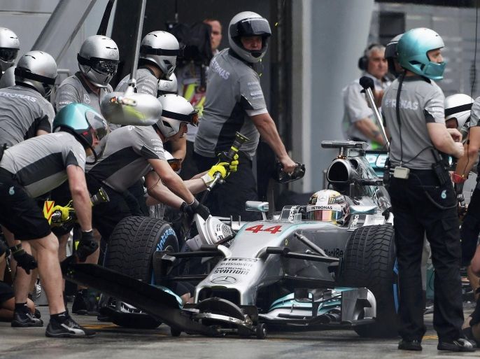 Crew members work on the car of Mercedes Formula One driver Lewis Hamilton of Britain during the qualifying session for the Malaysian F1 Grand Prix at Sepang International Circuit outside Kuala Lumpur, March 29, 2014. REUTERS/Peter Lim/Pool (MALAYSIA - Tags: SPORT MOTORSPORT F1)