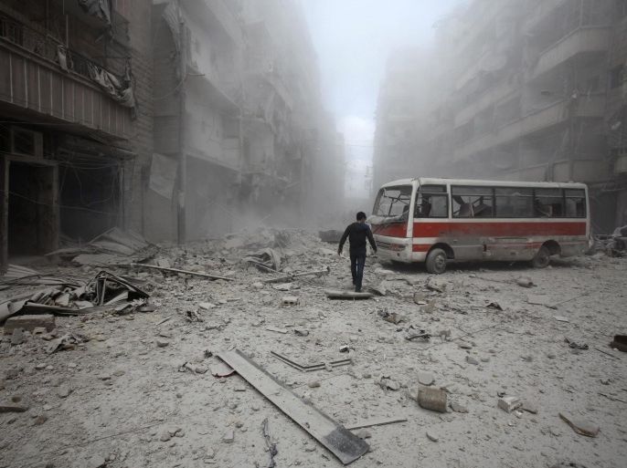 A man inspects the damage at a site hit by what activists said were barrel bombs dropped by forces loyal to Syria's President Bashar al-Assad in Aleppo's district of al-Sukari March 16, 2014. REUTERS/Ammar Abdullah