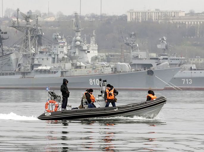epa04106531 Russian navy crew members on a patrol boat guard the Russian military ships of the Black Sea Fleet with destroyers 'Smetlivyy' (back L) and 'Kerch' (back R) in the port of Sevastopol, Crimea, Ukraine, 02 March 2014. Russia ratcheted up the tension over Ukraine on 01 March when its upper house of parliament authorised the use of armed forces inside Europe's second largest country by territory. Russia ratcheted up the tension over Ukraine on 01 March when its upper house of parliament authorised the use of armed forces inside Europe's second largest country by territory. EPA