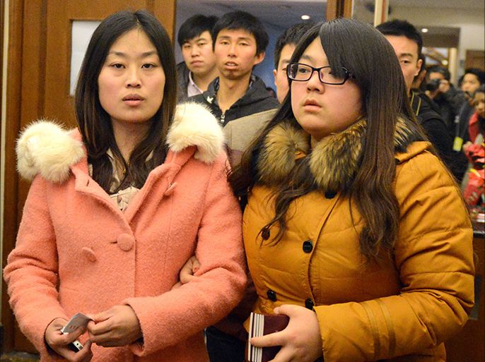 Relatives of victims from the missing Malaysia Airlines Boeing 777-200 plane leave after applying for their Chinese passports to be ready for travel to be closer to the rescue operations, in Beijing on March 10, 2014