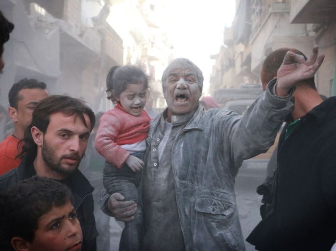 Aleppo, -, SYRIA : A Syrian man holds a crying girl as he gestures following an air strike by government forces on the Sahour neighbourhood of the northern Syrian city of Aleppo on March 6, 2014. AFP PHOTO / FADI AL-HALABI / AMC