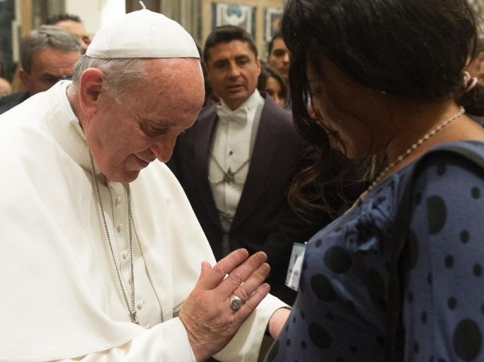 In this photo released by Vatican newspaper L'Osservatore Romano, Pope Francis blesses a pregnant woman during a meeting with the Italian pro-life movement, at the Vatican Friday, April 11, 2014. (AP Photo/L'Osservatore Romano)