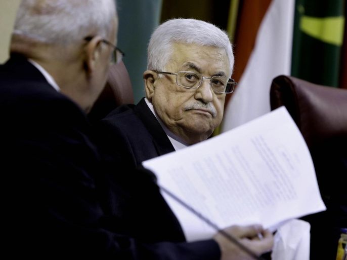 Palestinian President Mahmoud Abbas, right, listens to his chief negotiator Saeb Erekat during a meeting with Arab foreign ministers requested by Abbas at the League's headquarters in Cairo, Egypt, Wednesday, April 9, 2014. (AP Photo/Amr Nabil)