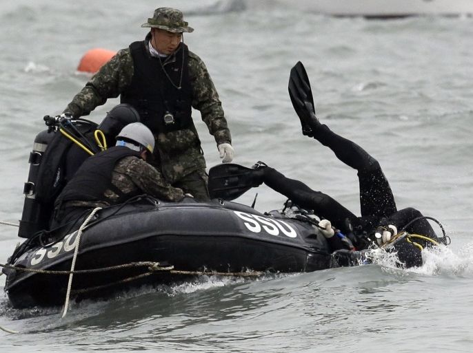South Korean navy's frogman dives into a water search passengers believed to have been trapped in the sunken ferry Sewol in the water off the southern coast near Jindo, south of Seoul, South Korea, Saturday, April 19, 2014. The captain of the sunken South Korean ferry was arrested Saturday on suspicion of negligence and abandoning people in need, as investigators looked into whether his evacuation order came too late to save lives. Two crew members were also arrested, a prosecutor said. (AP Photo/Lee Jin-man)