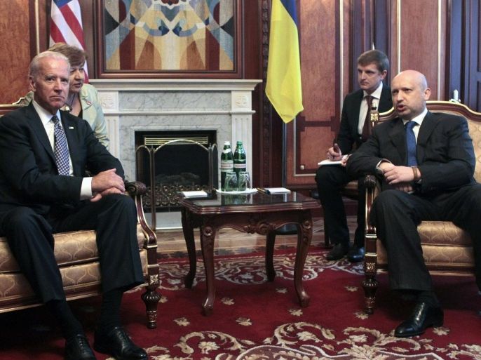 U.S. Vice President Joe Biden, left, sits with acting Ukrainian President Oleksandr Turchynov during a meeting in Kiev, Ukraine, Tuesday, April. 22, 2014. Vice President Joe Biden told Ukrainian political leaders Tuesday that the United States stands with them against "humiliating threats" and encouraged them to root out corruption as they rebuild their government. In the most high-level visit of a U.S. official since crisis erupted in Ukraine, Biden told leaders from various political parties that he brings a message of support from President Barack Obama as they face a historic opportunity to usher in reforms. (AP Photo/Sergei Chuzavkov)