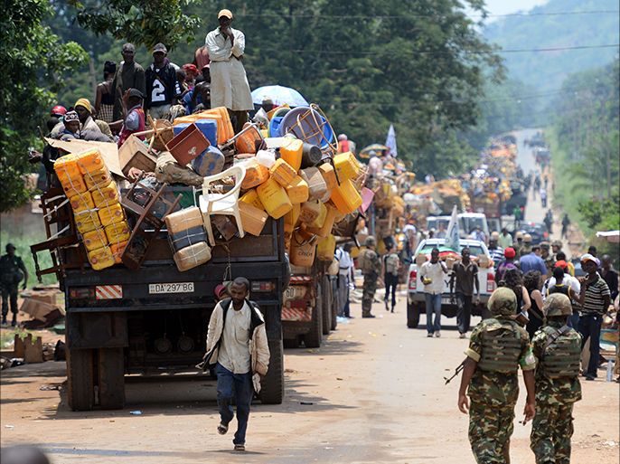 A convoy of vehicles carrying Muslims from the PK12 district, outside of Bangui, leave the city on April 27, 2014. About 1,300 Muslims who were hiding on the outskirts of Bangui, and were frequently attacked by predominantly Christian militias, left Bangui on Sunday in an impressive convoy escorted by the Misca African force, to relocate north of the country. AFP PHOTO / ISSOUF SANOGO