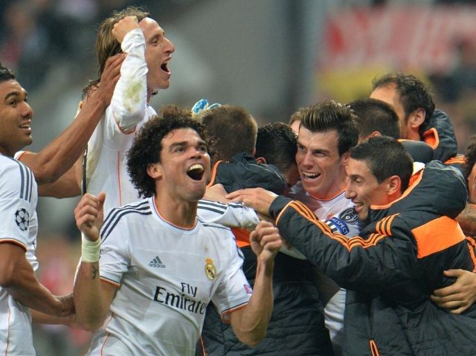 Real Madrid players celebrate at the end of the Champions League semifinal second leg soccer match between Bayern Munich and Real Madrid at the Allianz Arena in Munich, southern Germany, Tuesday, April 29, 2014. (AP Photo/Kerstin Joensson)