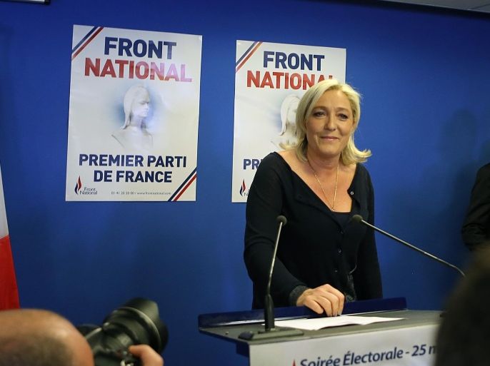 Far right party National Front leader Marine Le Pen poses for photographers before addressing reporters at the party's headquarters in Nanterre, west of Paris, Sunday May 25, 2014, following the victory of her party in the European Elections. Poster in background reads: First Party of France.(AP Photo/Remy de la Mauviniere)