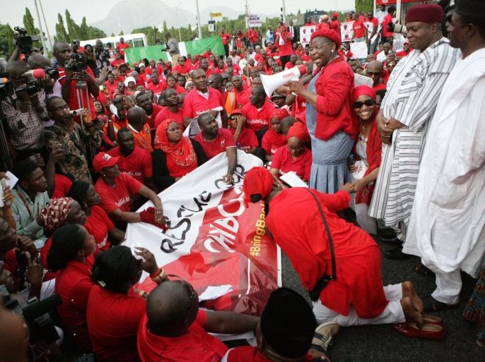 Civil society group leader Oby Ezekwesili speaks to members of civil society groups and organizations taking part in a protest against the abduction of the Chibok schoolgirls, after they were prevented from reaching the president's residence in Abuja on May 22, 2014. Protesters today took their call for the release of more than 200 schoolgirls kidnapped by Boko Haram to Nigeria's president, as US military personnel headed to Chad as part of the rescue effort. About 200 protesters, most of them wearing red, set off for the Presidential Villa of Goodluck Jonathan, calling for the government to do more in the search and rescue efforts. AFP PHOTO / PIUS UTOMI EKPEI