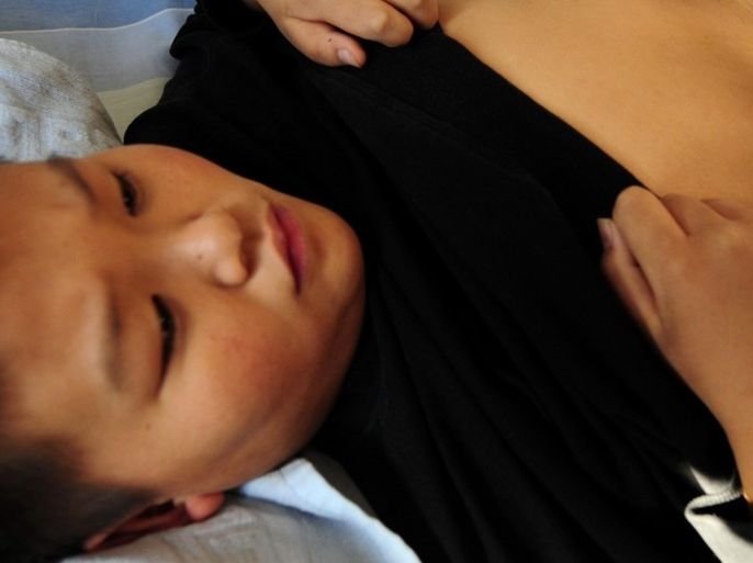 A Chinese youth receives acupuncture treatment with needles inserted into his belly at a weight reduction clinic in Tianjin on November 18, 2008. As China is about to mark thirty years since economic reforms opened the country from the darkness of the cultural revoulution, an entire population of "little emperors" from the one-child policy which was instituted around the same time in the late 1970's are growing up fatter and overweight, a result of a more sedentary lifestyle around televisions, computers and video-games and an ever-oncreasing popularity of high-fat, high-sodium, fast foods.