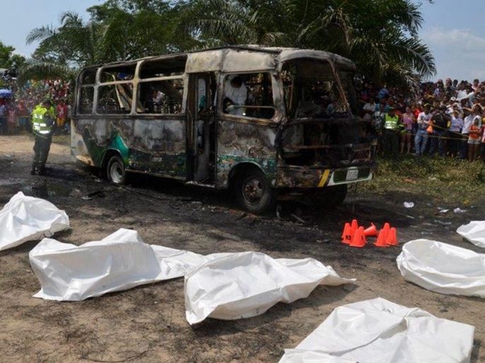 A handout picture provided by the daily El Heraldo shows forensic experts inspecting the site of a burned bus supposedly set on fire due to a mechanic failure, in Fundacion, department of Magdalena, Colombia, 18 May 2014. The bus was picking up children from an event at a church in Fundacion. At least 30 children died in the accident. EPA/EL HERALDO