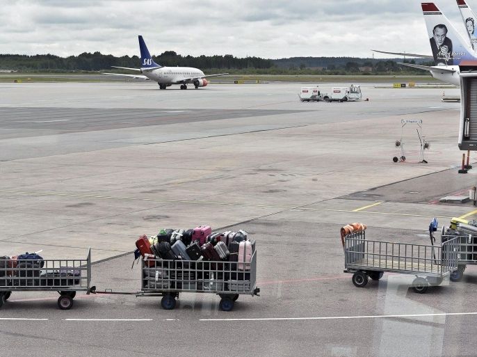 Baggage carts stand at the empty tarmac at Stockholm's Arlanda airport after landings and take-offs were halted early 17 August 2013. A technical problem closed down the communication between control tower and airplanes, also affecting back-up systems and causing planes to be re-routed to other nearby airports. EPA/ANDERS WIKLUND SWEDEN OUT