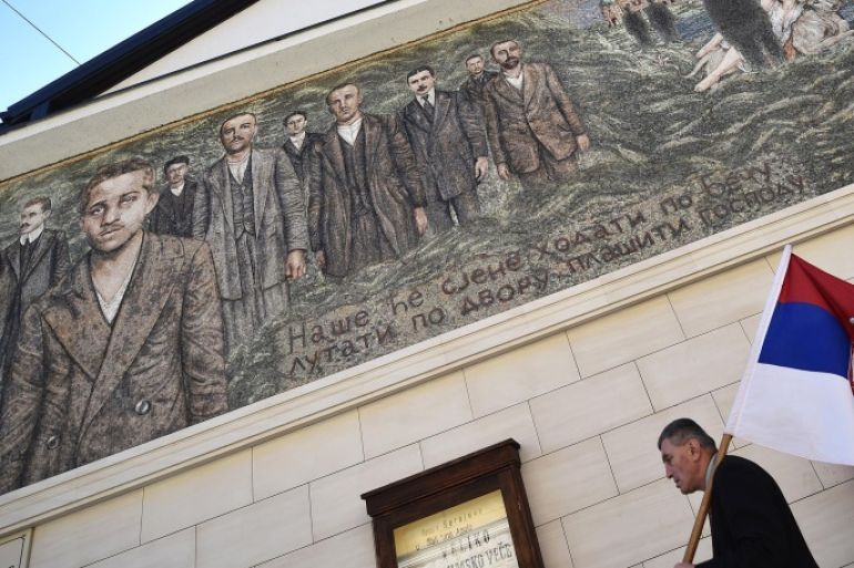 A man walks past a mural depicting Gavrilo Princip, the man who killed Austrian Archduke Franz Ferdinand one hundred years ago, and other members of 'Mlada Bosna' movement in the Bosnian Serb-run town of Visegrad, on June 28, 2014. Sarajevo on Saturday marks 100 years since the assassination that triggered World War I, plunging Europe into the bloodiest conflict it had ever seen and redrawing the world map. With the people of the Balkans still deeply divided over the legacy of that fateful day, separate commemorations were to be held to mark the occasion. AFP PHOTO / ANDREJ ISAKOVIC
