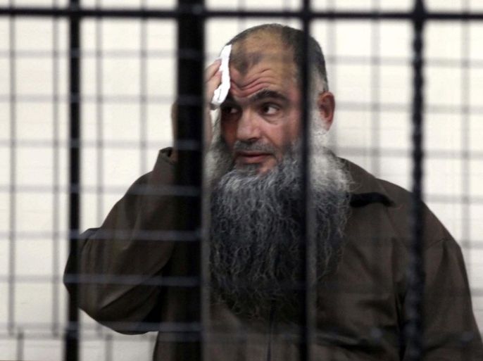 Radical Islamist cleric Omar Mahmoud Othman, Abu Qatada, looks from behind bars during his trial at Jordan's State Security Court in Amman, Jordan, 26 June 2014. A Jordanian court on 26 June acquitted the radical cleric Abu Qatada of conspiring to commit acts of terrorism in the 1990s. He was accused of involvement in a plot to carry out a series of attacks against Western diplomats and government targets in Amman. He will remain in jail on separate charges of planning to attack tourists in Jordan at the turn of the century, known as the Millennium Bombings plot.