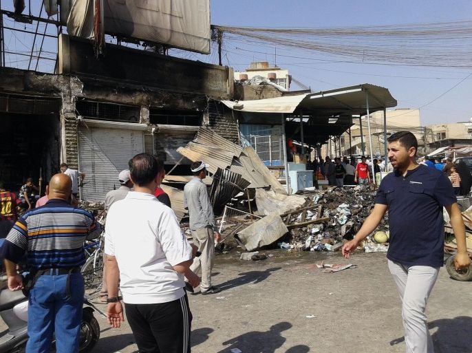 People inspect buildings damaged by an Iraqi government airstrike in the northern city of Mosul, Iraq, Saturday, June 28, 2014. The Iraq military carried out three airstrikes on the insurgent-held city of Mosul early Saturday. (AP Photo)