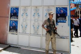 An Iraqi Turkoman fighter stands guard outside the Iraqi Turkmen Front Headquarters in the oil-rich city of Kirkuk, 180 miles (290 kilometers) north of Baghdad, Iraq, Monday, June 16, 2014. The town of Tal Afar, with a population of some 200,000 people, was taken just before dawn, Mayor Abdulal Abdoul told The Associated Press. The town's ethnic mix of mostly ethnic Shiite and Sunni Turkomen raises the grim specter of large-scale atrocities by Sunni militants from the al-Qaida-inspired Islamic State of Iraq and the Levant, who already claim to have killed hundreds of Shiites in areas they captured last week. (AP Photo/Emad Matti)