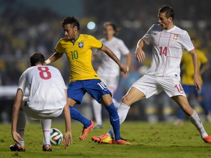 SAO PAULO, BRAZIL - JUNE 06: Neymar (C) of Brazil and Matic (R) and Radosav Petrovic of Serbia compete for the ball during the International Friendly Match between Brazil and Serbia at Morumbi Stadium on June 06, 2014 in Sao Paulo, Brazil.