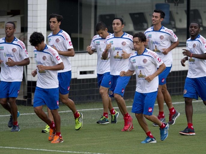 Costa Rica's national soccer team players run on the pitch during a training session in Santos, Brazil, , Saturday, June 21, 2014. Costa Rica stunned the football world by beating former champions Italy and Uruguay in one of the toughest groups in the soccer World Cup, becoming the first team from Group D to advance to the knockout stage. (AP Photo/Eduardo Verdugo)