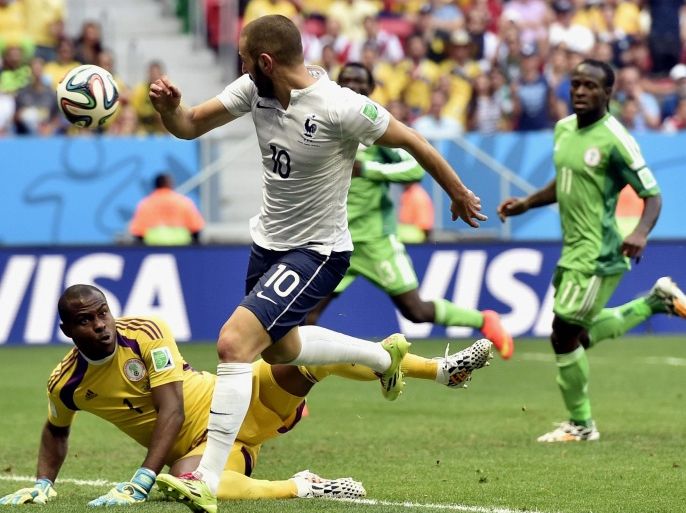 Nigeria's goalkeeper Vincent Enyeama makes a save from France's Karim Benzema (10) during the World Cup round of 16 soccer match between France and Nigeria at the Estadio Nacional in Brasilia, Brazil, Monday, June 30, 2014. (AP Photo/Martin Meissner)