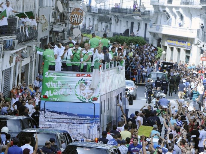 Algerian national soccer team players (atop bus) are welcomed by soccer fans after their return from the FIFA World Cup, in Algiers, Algeria, 02 July 2014. Algeria lost their FIFA World Cup 2014 round of 16 soccer match against Germany 1-2 in extra-time on 30 June.