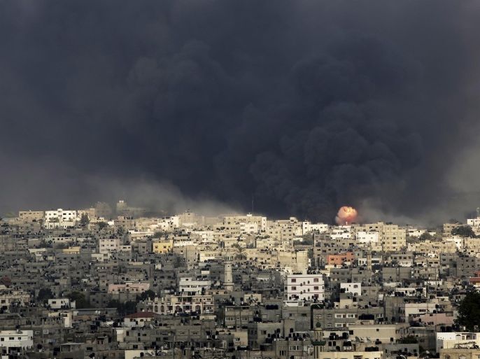 Smoke and flare of an explosion rise after an Israeli missile hit the Shijaiyah neighborhood in Gaza City, northern Gaza Strip, Sunday, July 20, 2014. The neighborhood came under heavy tank fire Sunday as Israel widened its ground offensive against Hamas, causing hundreds of panicked residents to flee. (AP Photo/Adel Hana)