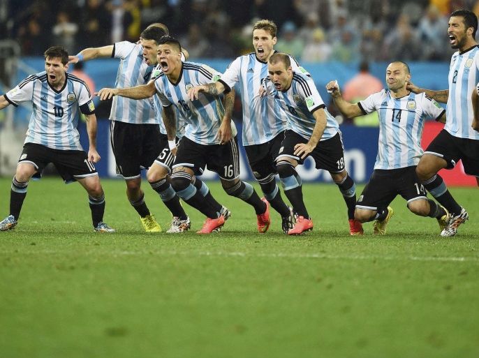 Argentina's national soccer players celebrate after their teammate Maxi Rodriguez scored the decisive goal during a penalty shoot-out against the Netherlands at their 2014 World Cup semi-finals at the Corinthians arena in Sao Paulo in this July 9, 2014 file photo. Pictured are (L-R) Argentina's Lionel Messi, Pablo Zabaleta , Martin Demichelis , Marcos Rojo , Lucas Biglia , Rodrigo Palacio , Javier Mascherano, Ezequiel Garay and Sergio Aguero. REUTERS/Dylan Martinez/Files (BRAZIL - Tags: SOCCER SPORT WORLD CUP) ATTENTION EDITORS - PICTURE 18 OF 20 FROM ARGENTINA'S JOURNEY TO THE WORLD CUP FINAL
