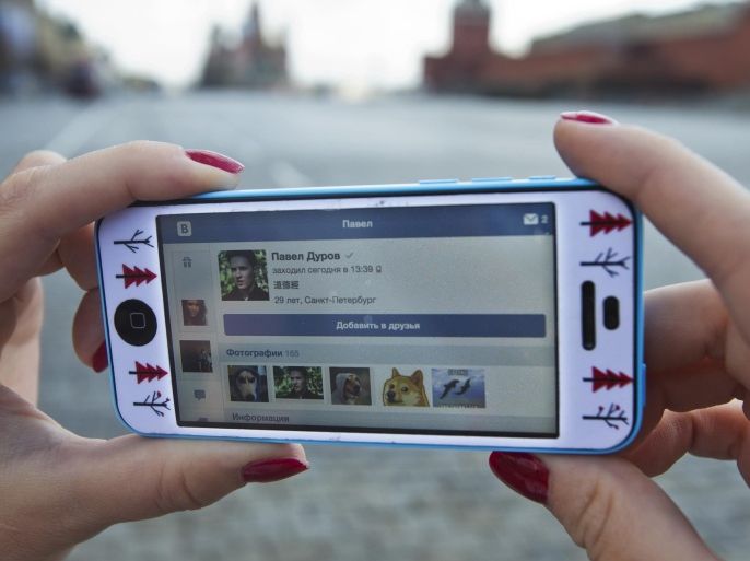 A user of Russia’s leading social network internet site VKontakte, poses holding an iPhone showing the account page of Pavel Durov, the former CEO and founder of VKontakte, in Red Square in Moscow, Russia, Wednesday, April 23, 2014. The network’s founder, Pavel Durov, described as Russia’s Mark Zuckerberg (founder of Facebook), left his post as CEO on Tuesday April 22, 2014, and is reported to have left Russia, one week after he posted online what he said were documents from the security services demanding personal details from 39 Ukraine-linked groups on VKontakte.(AP Photo/Pavel Golovkin)