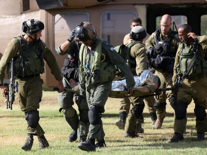 Israeli soldiers transport a wounded soldier from a helicopter at the Soroka Hospital in Beersheba, Israel, 30 July 2014. On the 23rd day of the Israeli offensive in Gaza the death toll there has reached 1,283. Fifty-three Israeli soldiers, two Israeli civilians and one Thai national have been killed, and hundreds have been wounded.
